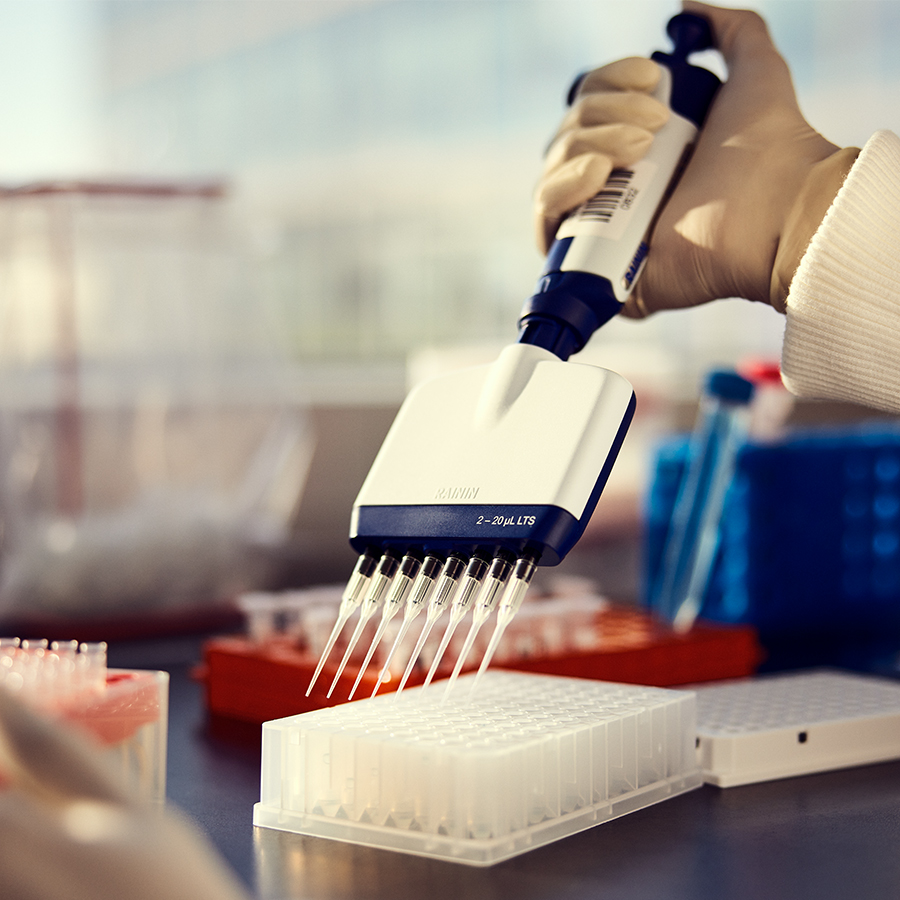 scientist reaching for sample in sequencing lab